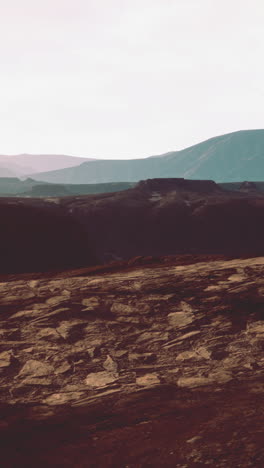 a vast desert landscape with canyons and mountains in the distance