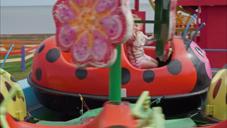 Happy-toddler-waves-and-smiles-on-the-carousel-merry-go-round-ride