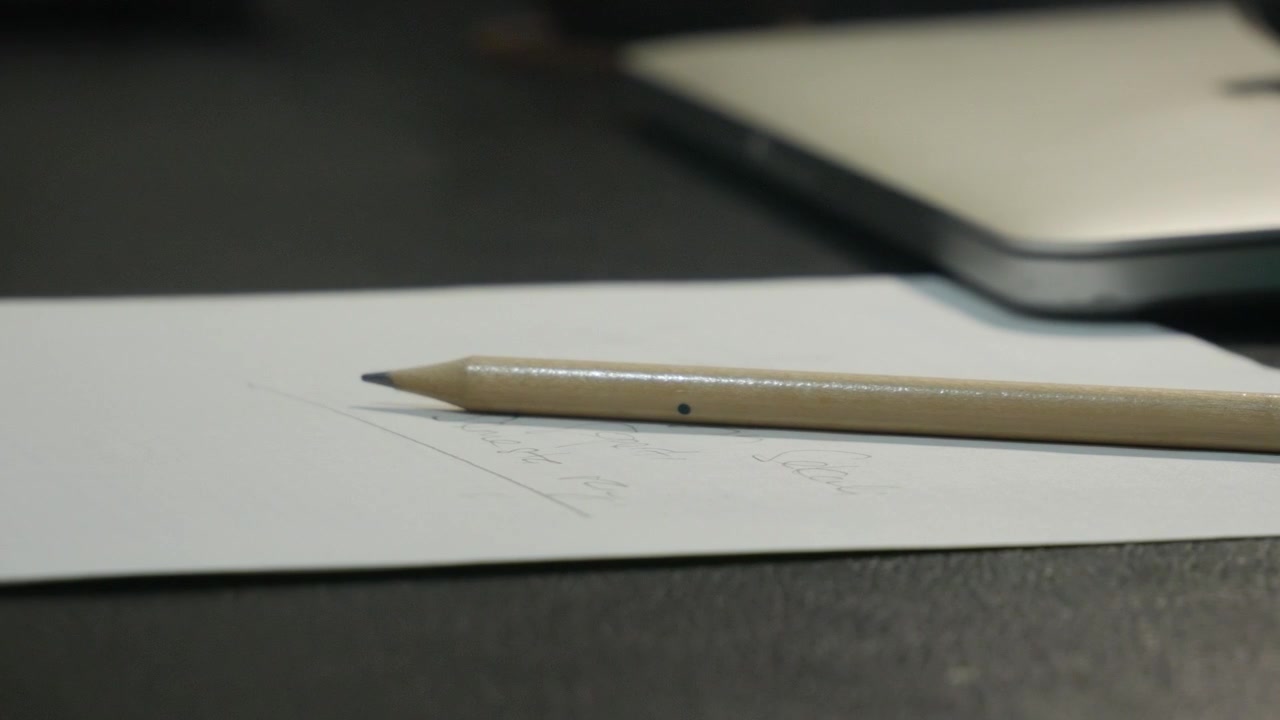 Close-Up of Pencil on Handwritten Paper.