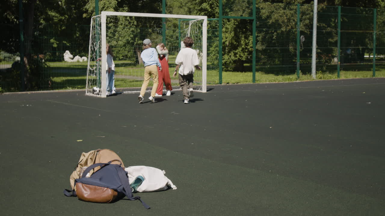 Children playing soccer on a sunny outdoor field