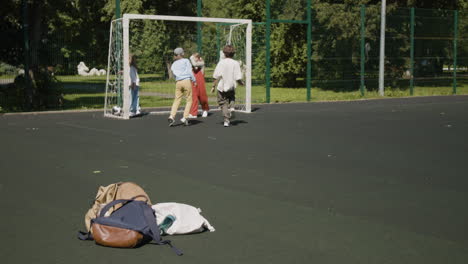 children playing soccer on a sunny outdoor field