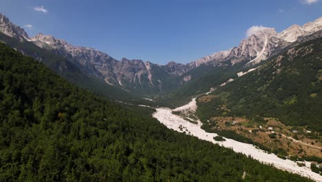 unexplored forest with green pine trees on slopes of rocky mountains near valley of valbona in albania