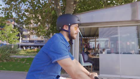 young man cycling on busy street.