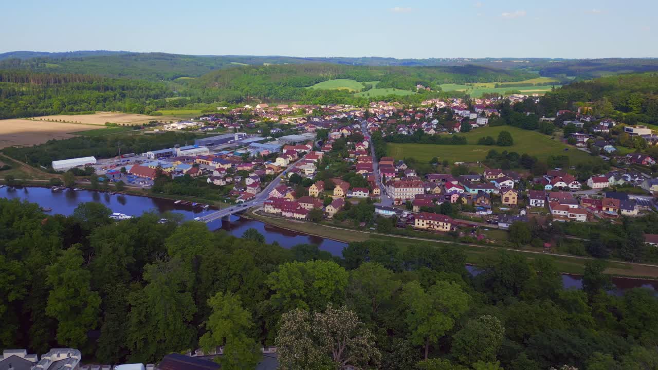 Village in valley, Bridge river, Nice aerial top view flight Hlubok&aacute; Nad Vltavou is a Fairy tale castle in Czech Republic Europe, summer day 2023