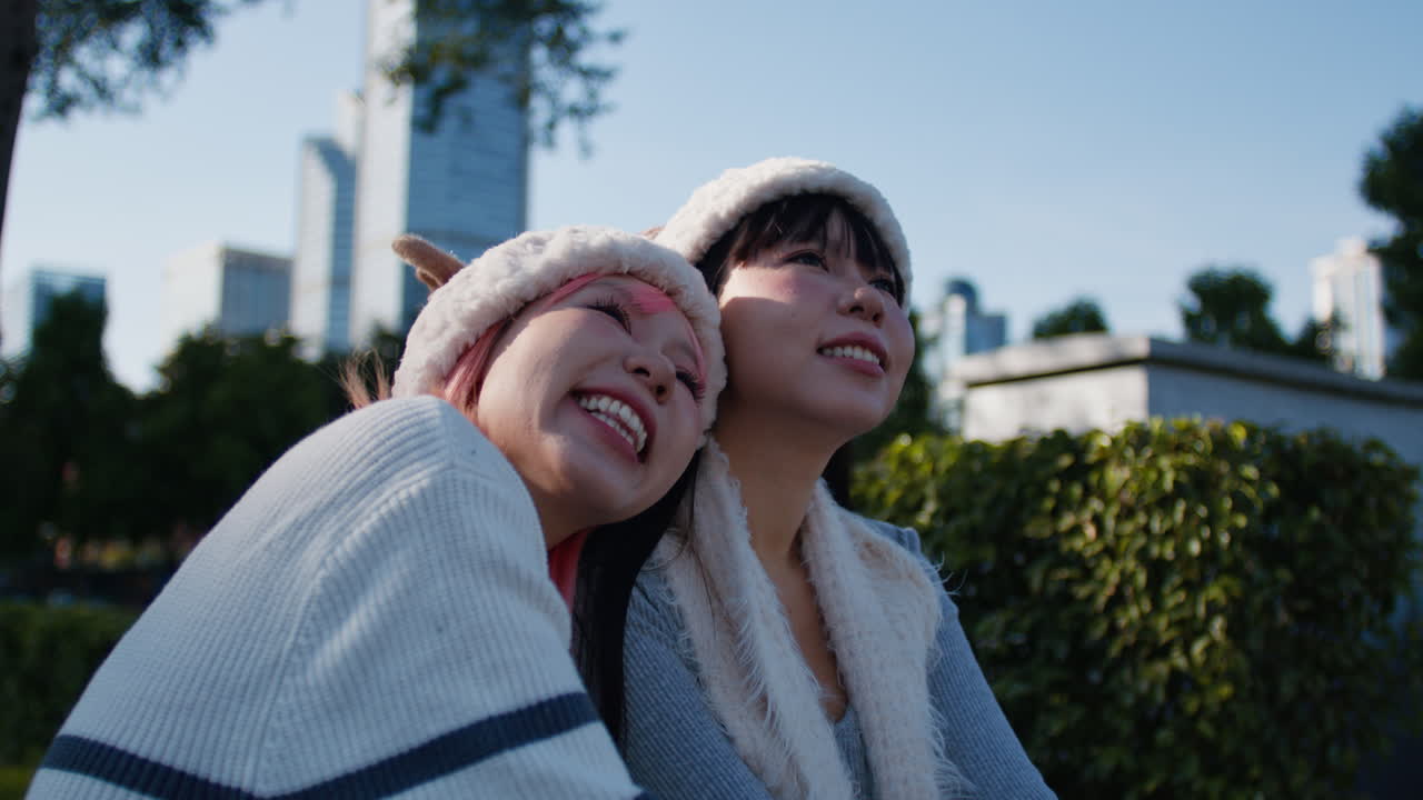 Two Friends Enjoying a Sunny Day in the City Park