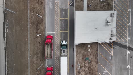 Aerial-shot-pointing-straight-down-on-a-Weigh-Station-where-a-truck-rolls-in-for-inspection