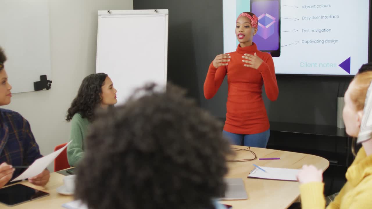 Happy diverse business people discussing work during meeting at office