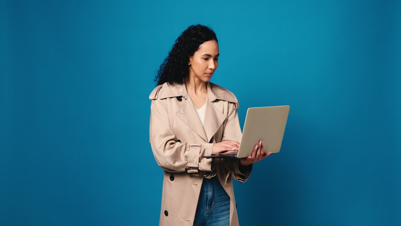 Woman using laptop in studio