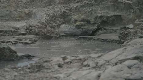 Boiling-hot-geothermal-volcanic-mud-pool,-closeup-shot-steamy-lake-bubbling-mud-and-steam