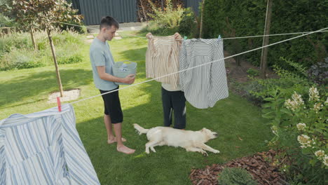 family doing laundry in the backyard