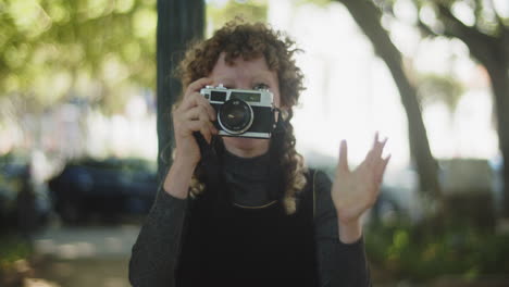 happy female photographer taking pictures outdoors