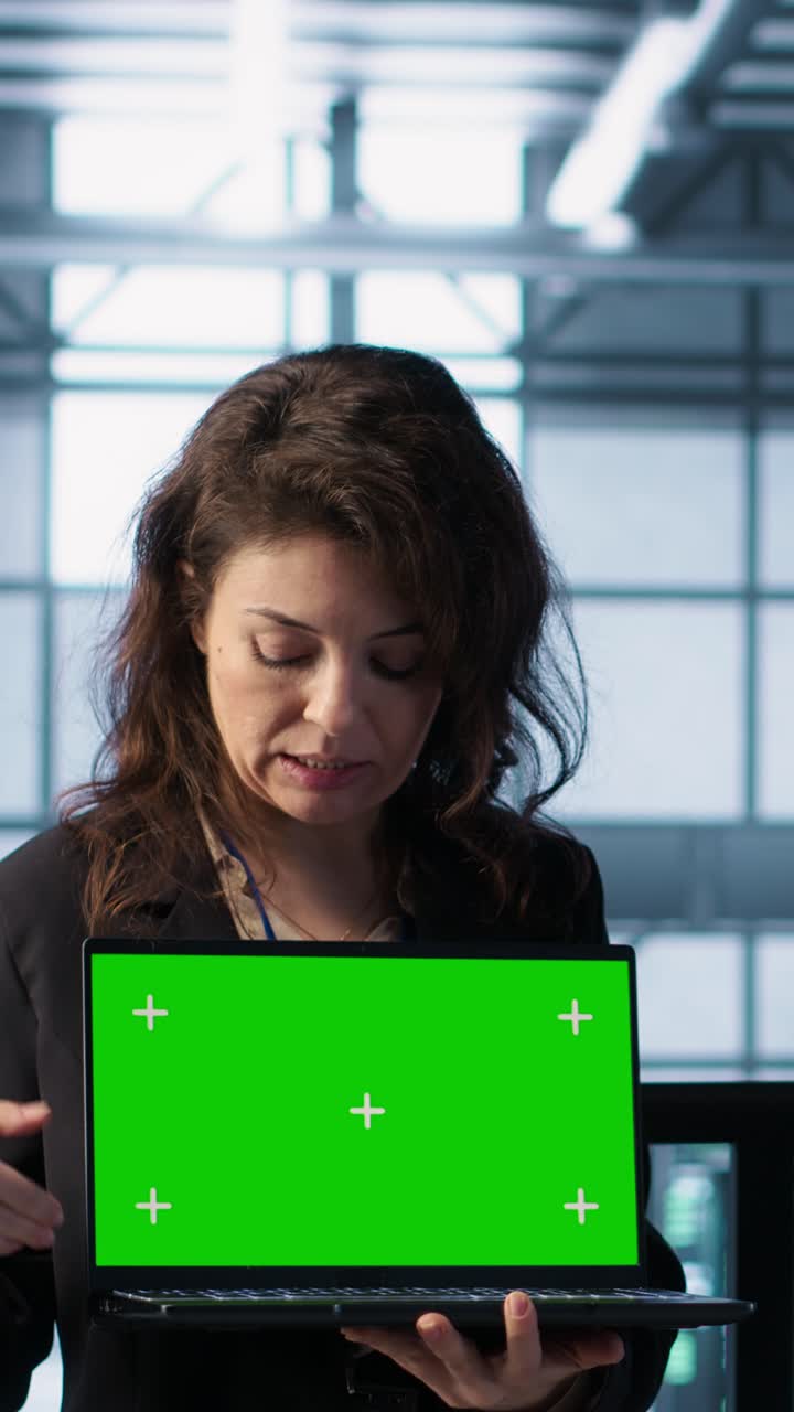 Vertical video Server room coworkers using mockup notebook, adjusting power settings