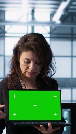 vertical video server room coworkers using mockup notebook, adjusting power settings