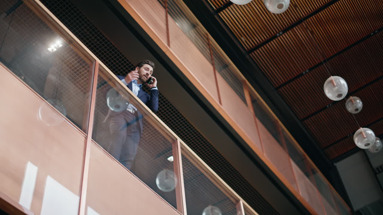 Entrepreneur calling glass balcony business center bottom view. Manager talking