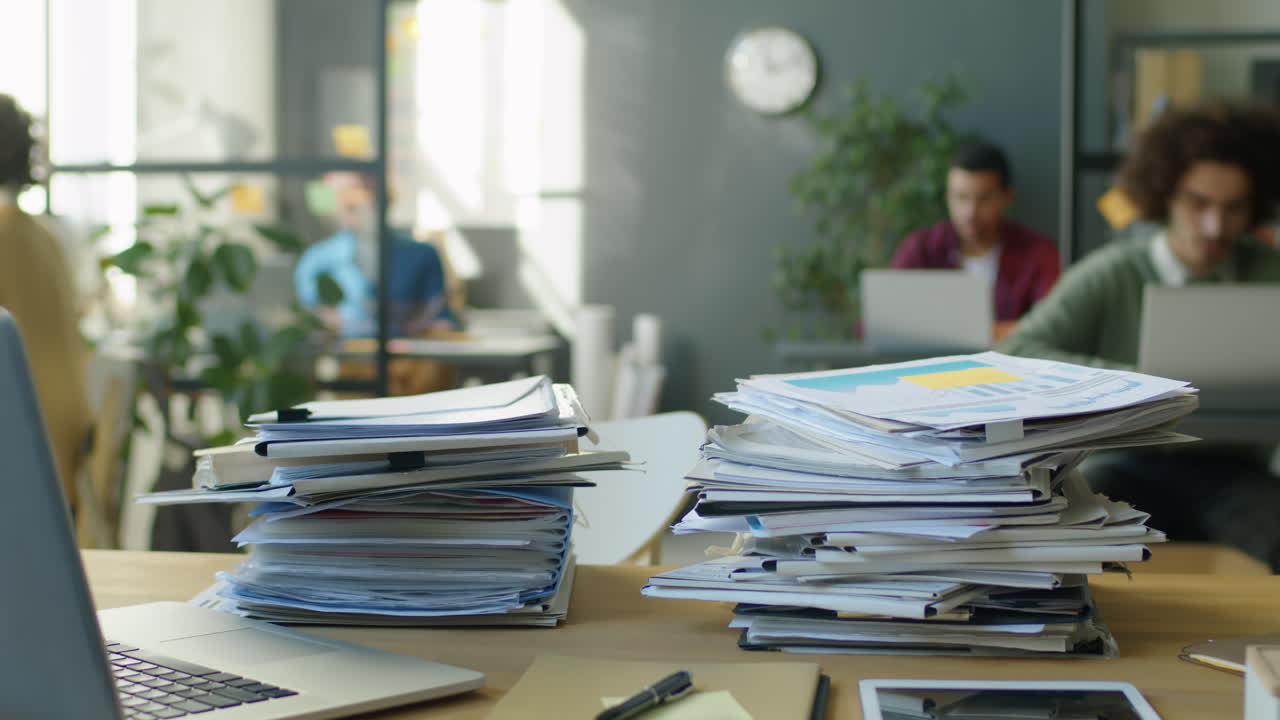 Timelapse of Office Workers Stacking Papers on Desk