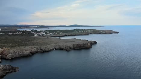 na macaret in menorca, spain seen from drone aerial view above rocky cliffs