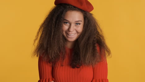 stylish caucasian curly haired woman sending a kiss.