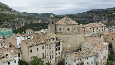 ancient church of san pedro built on highest part of cuenca, spain with cliff-edge houses