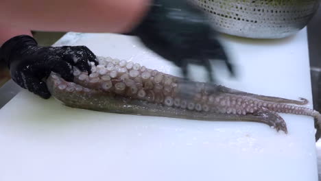 un chef limpia pulpo. mariscos crudos