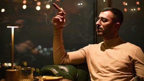 man smoking cigar in a luxury lounge with city view