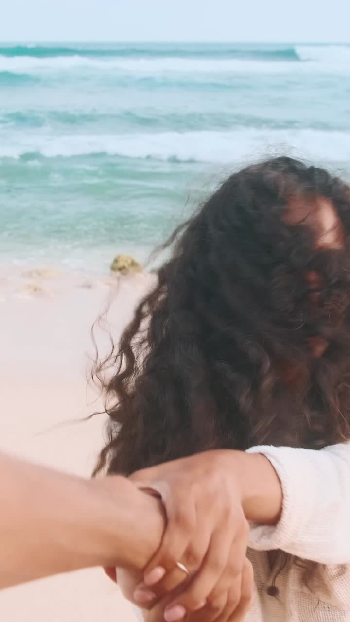 Young couple enjoys beach time together on sunny coastal day