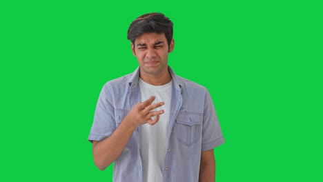 Indian-boy-disgusted-by-bad-smell-Green-screen