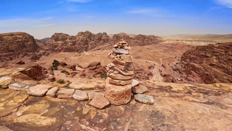 stones piled at the edge of the flat rock. amazing rocky landscape of sunny hot jordan, west asia.