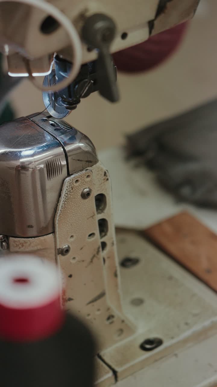 Vertical macro view of industrial sewing machine used in factory production