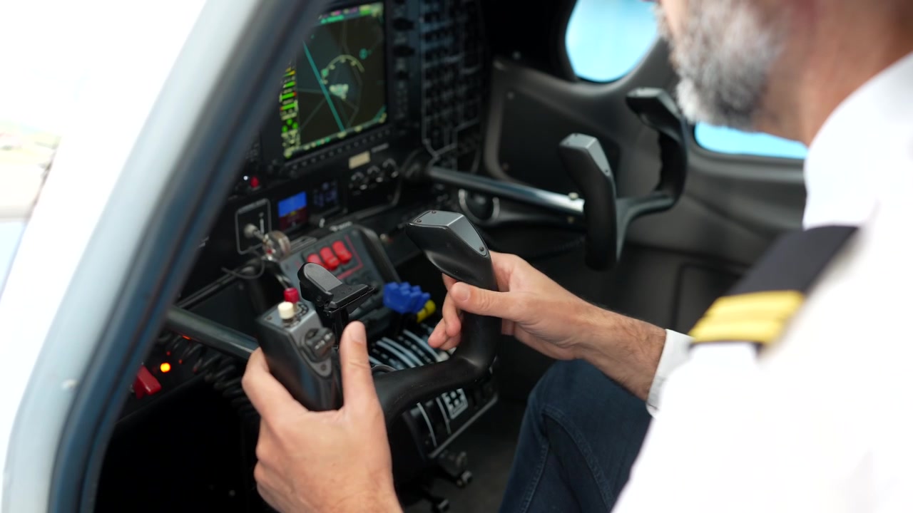 Pilot's Hands Operating Controls in Airplane Cockpit