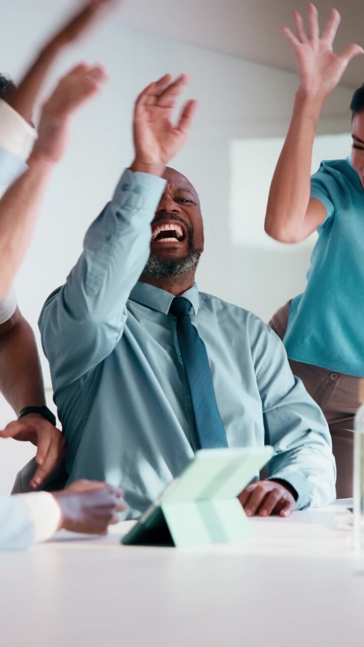 Diverse Business Team Celebrating Success in Office Meeting