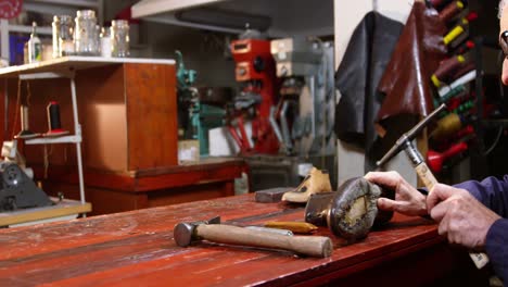 shoemaker hammering on a shoe