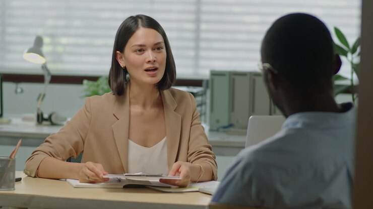 Female HR Manager Having Meeting with Job Applicant in Office
