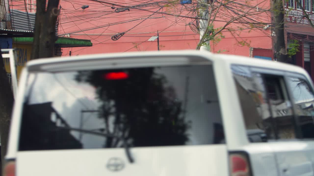 Street view clothes vendor Zone 18 Guatemala City, people walking, vehicles driving busy street