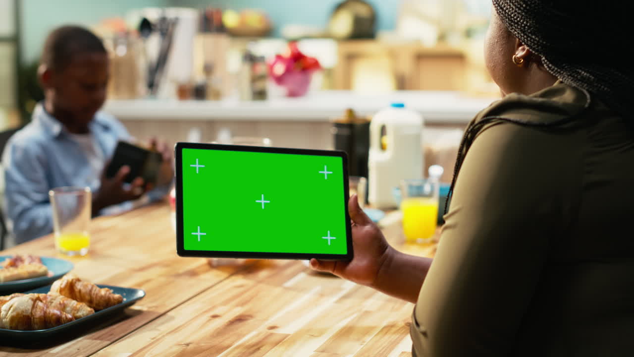 Family using tablet at breakfast