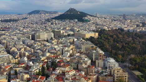 aerial - general cloudy shot of athens, greece with mount lycabettus in the background