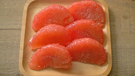 fresh red pomelo fruit or grapefruit on plate