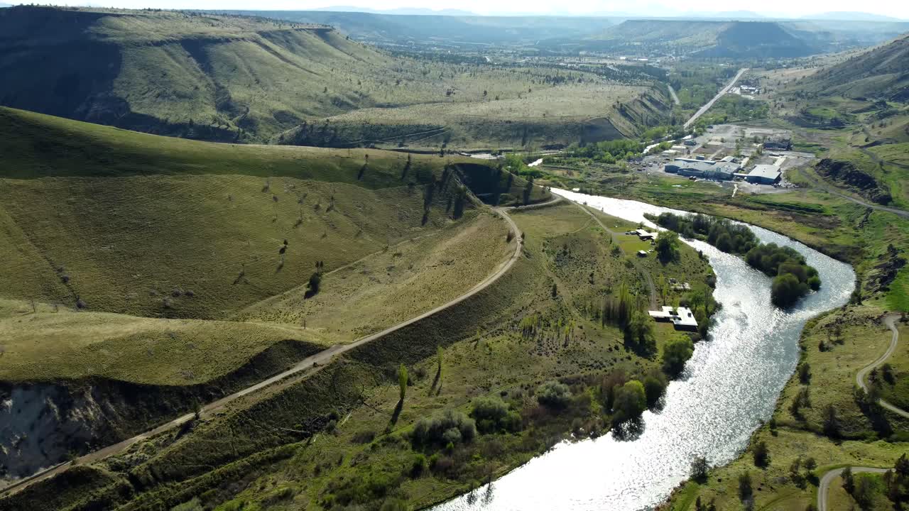 US, Oregon, Warm Springs, , 2025-04-19 - Drone view of an old abandoned train tunnel built in 1906 on the Deschutes River. Tthe railroad grade curves to the left and the tunnel in the center.