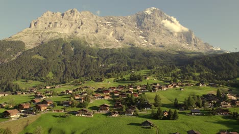 Pushing in towards Mount Eiger flying over Grindelwald W&auml;rgistal with stunning view of Eiger North Face in beautiful evening light