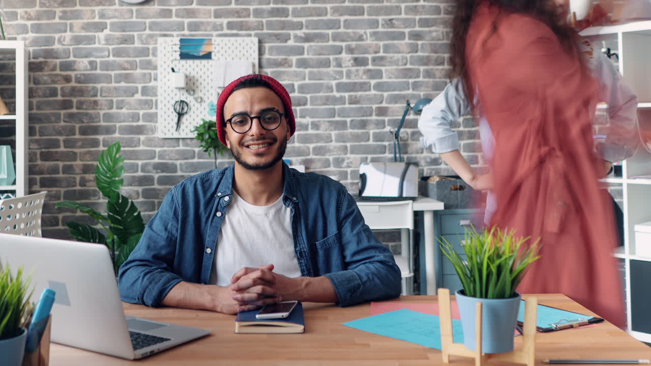 Man Working in Office with Colleagues