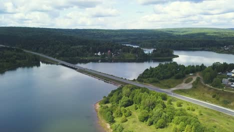 aerial view of a bridge over a lake and forest