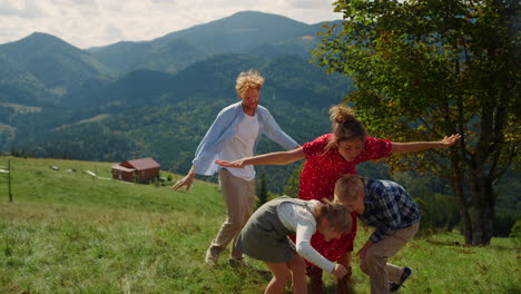 family spreading hands wings playing outdoor. couple with children having fun.