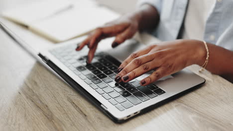 woman typing on a laptop