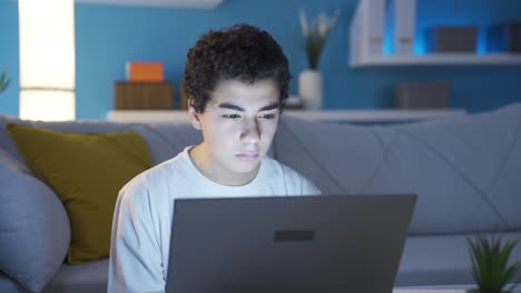 Boy-looking-at-laptop-serious-and-focused,-suspicious-approach.