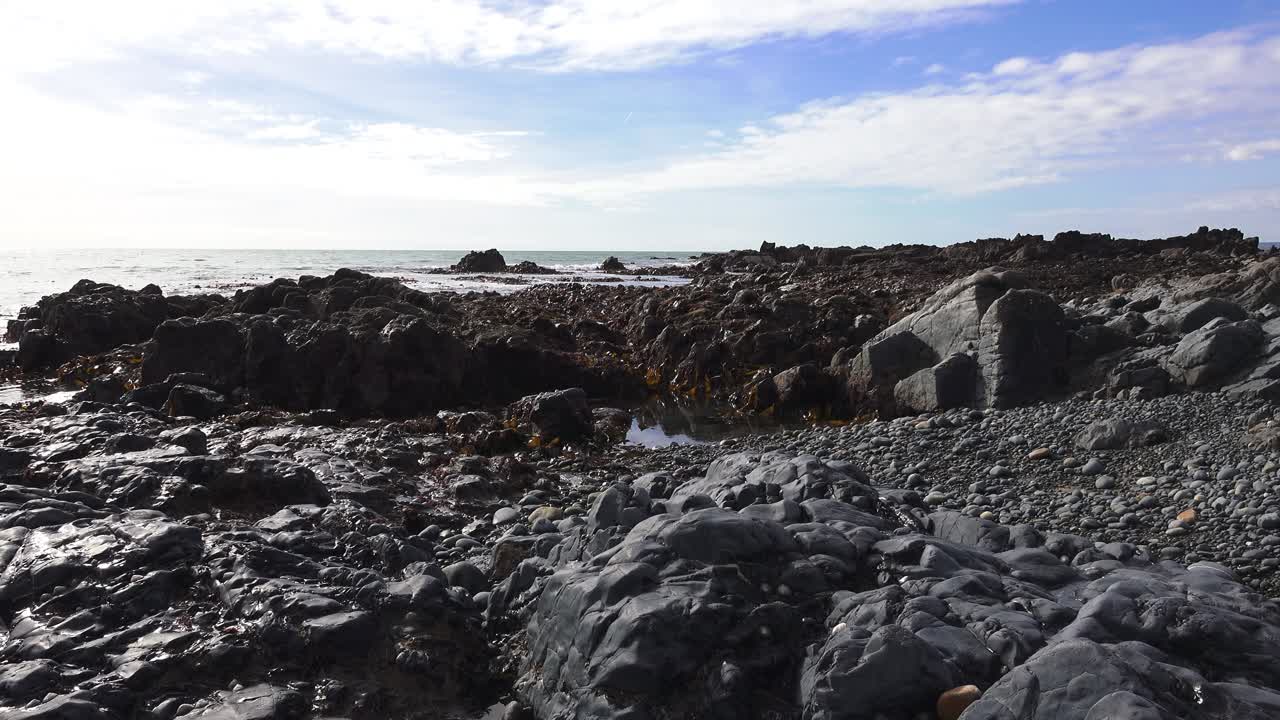 Rocky beach covered in seaweed incoming calm tides spring Copper Coast Waterford Ireland Epic Locations and seascapes