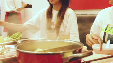 friends enjoying a hot pot dinner