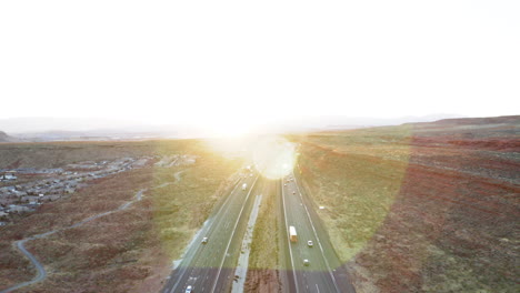 aerial view of highway traffic at sunset in a desert landscape