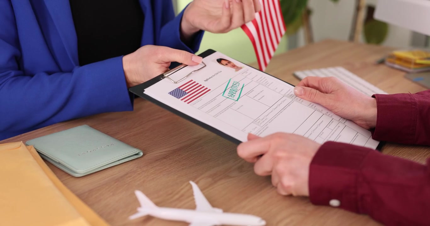Visa center employee informs woman about successful visa approval