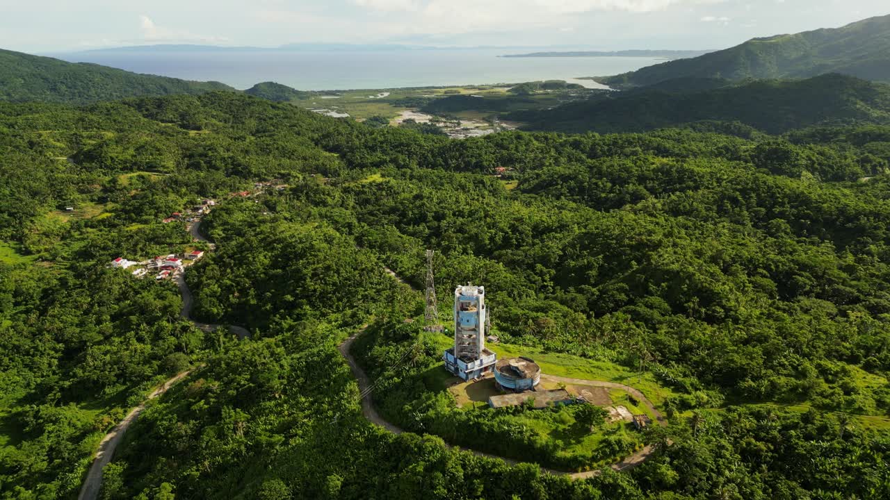 Overhead drone shot of PAGASA Doppler radar station overlooking island province greenery and lush hills at Catanduanes, Philippines