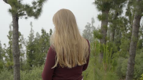 blonde woman cant see landscape because of thick fog from mountain top