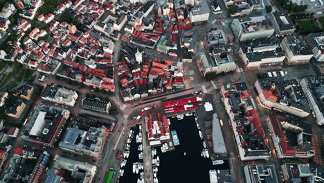 beautiful top down view drone shot from harbor and city of bergen, norway, water and houses seen from above, no people, daylight